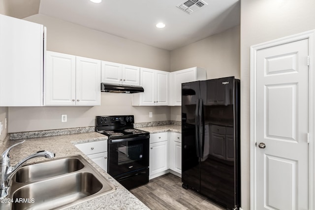 kitchen with white cabinetry, black appliances, sink, and hardwood / wood-style flooring