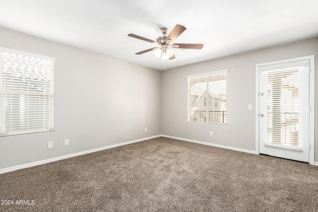 carpeted spare room with ceiling fan