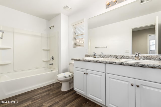 full bathroom with vanity, toilet,  shower combination, and hardwood / wood-style flooring