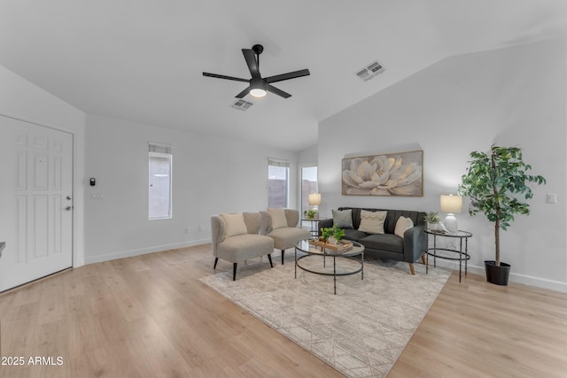 living area featuring lofted ceiling, a ceiling fan, visible vents, and wood finished floors