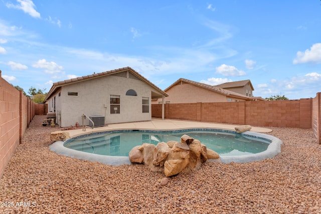 view of pool with a fenced in pool, a fenced backyard, a patio, and central AC