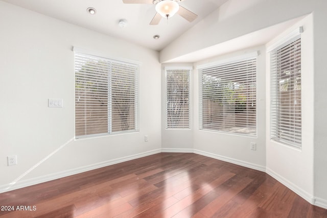 empty room featuring ceiling fan, dark hardwood / wood-style flooring, and vaulted ceiling