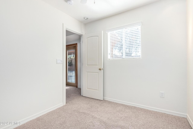 carpeted empty room with ceiling fan