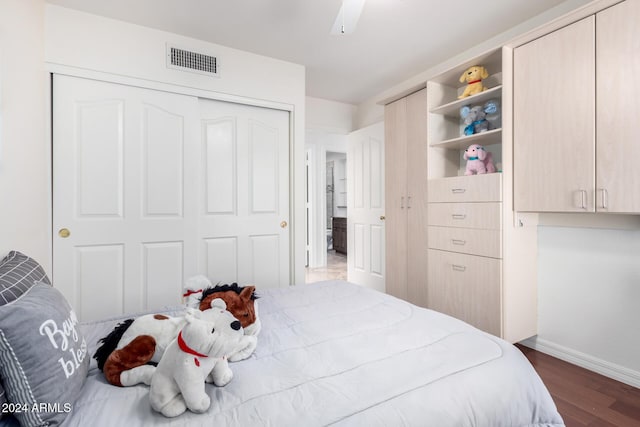 bedroom with dark hardwood / wood-style floors and ceiling fan