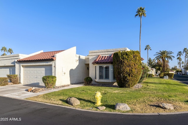 view of front of home featuring a garage and a front lawn