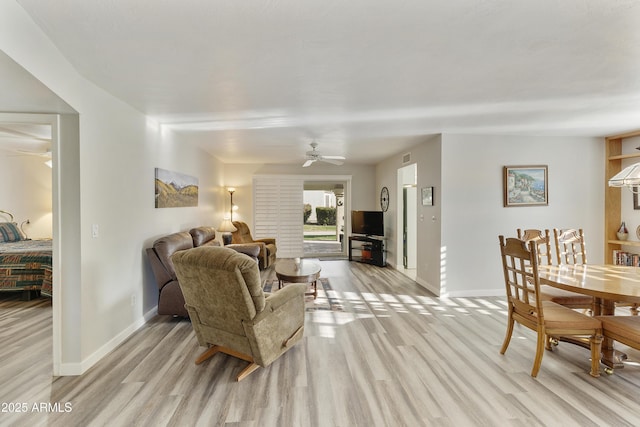 living room featuring ceiling fan and light wood-type flooring