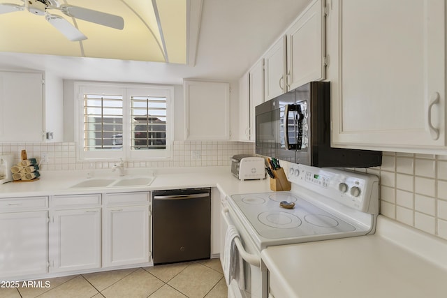 kitchen featuring white electric stove, dishwasher, sink, and white cabinets