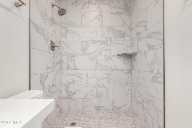 bathroom with a tile shower