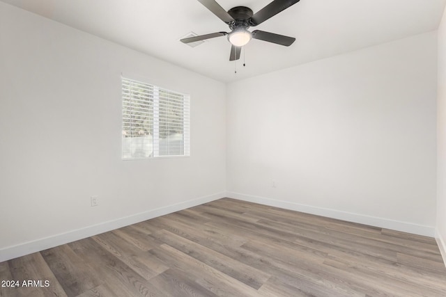 spare room with ceiling fan and light hardwood / wood-style flooring