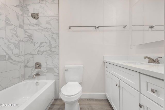 full bathroom with toilet, vanity, wood-type flooring, and tiled shower / bath