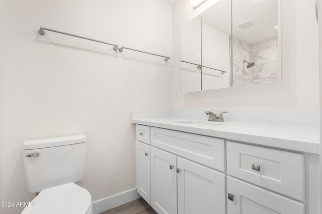 bathroom featuring hardwood / wood-style flooring, vanity, and toilet