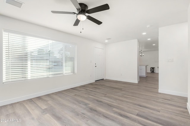 spare room featuring ceiling fan and light wood-type flooring