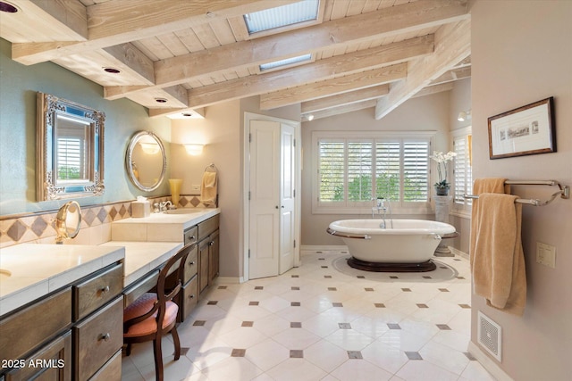 bathroom with vanity, a healthy amount of sunlight, wooden ceiling, and a bathtub