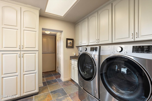 washroom featuring cabinets and washing machine and clothes dryer