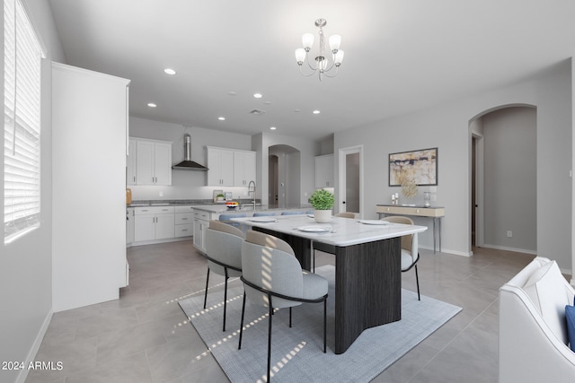 dining space featuring light tile flooring, sink, and an inviting chandelier