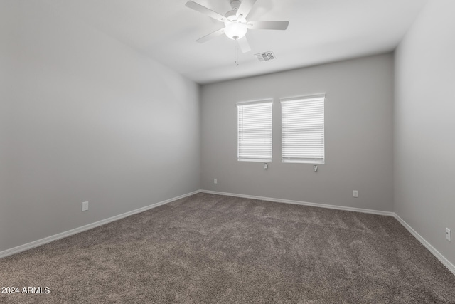 carpeted spare room featuring ceiling fan