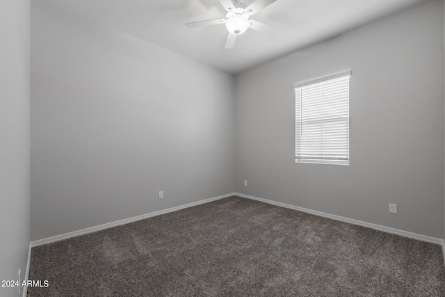 spare room with ceiling fan and carpet