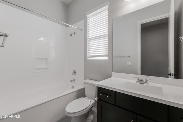 full bathroom with shower / bathing tub combination, toilet, large vanity, and a healthy amount of sunlight