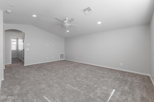 carpeted spare room featuring lofted ceiling and ceiling fan