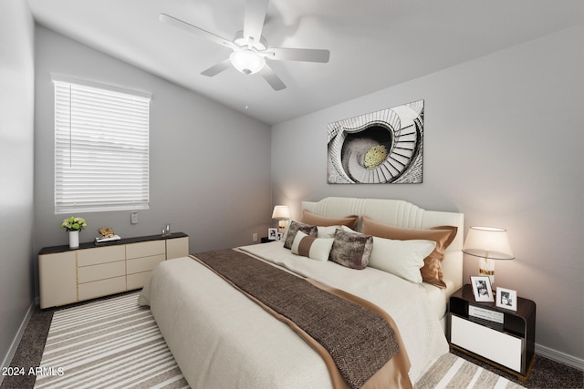 bedroom with lofted ceiling, ceiling fan, and light colored carpet