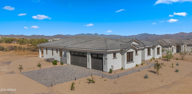 view of front of home with a mountain view and a garage