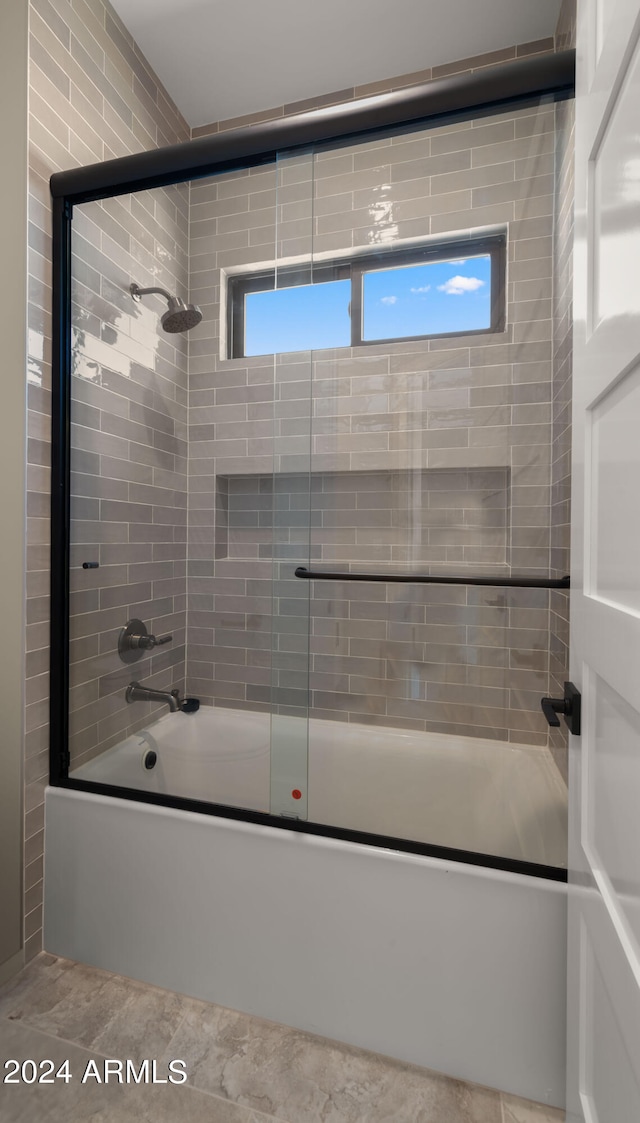 bathroom featuring combined bath / shower with glass door and a wealth of natural light