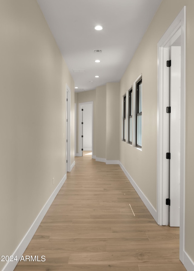 hall with light hardwood / wood-style floors