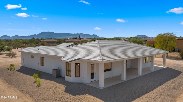 rear view of property featuring a patio, central AC, and a mountain view