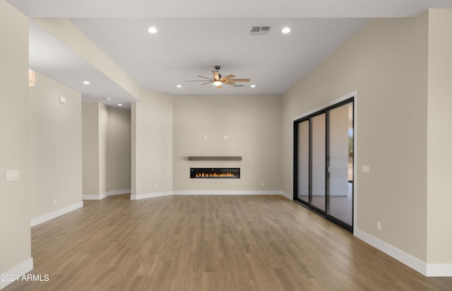 unfurnished living room with light hardwood / wood-style floors and ceiling fan