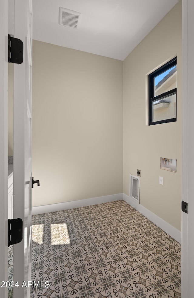 laundry room featuring tile patterned flooring, washer hookup, and hookup for an electric dryer