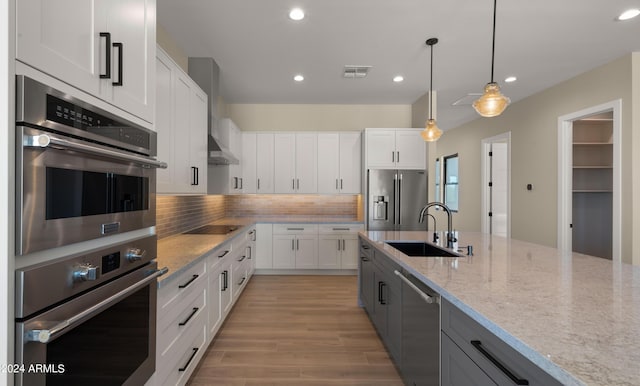 29811 N 154th St, Scottsdale, AZ 85262 - kitchen with white cabinets, recessed lighting, appliances with stainless steel finishes, light stone counters, and a sink