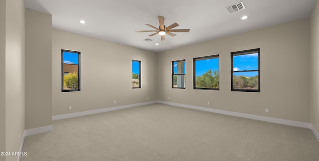 carpeted spare room with ceiling fan