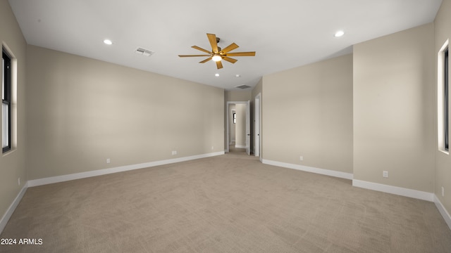 unfurnished room with ceiling fan and light carpet