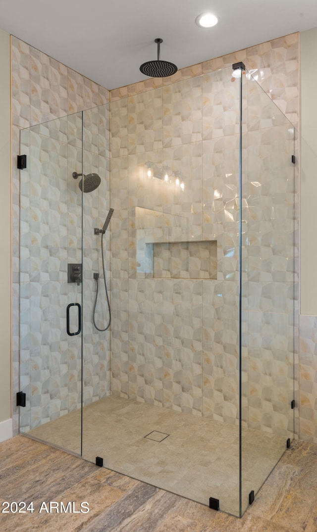 bathroom featuring hardwood / wood-style floors and walk in shower