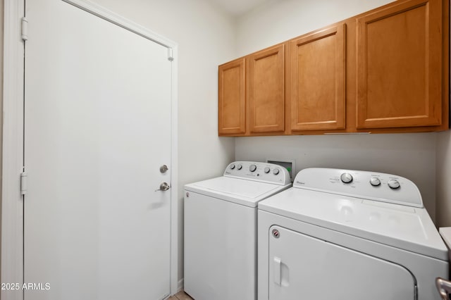 laundry area featuring cabinet space and washer and clothes dryer