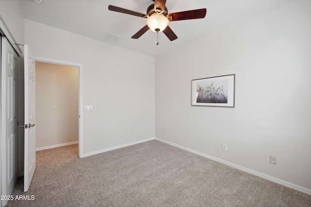 unfurnished bedroom with carpet floors, a closet, a ceiling fan, and baseboards