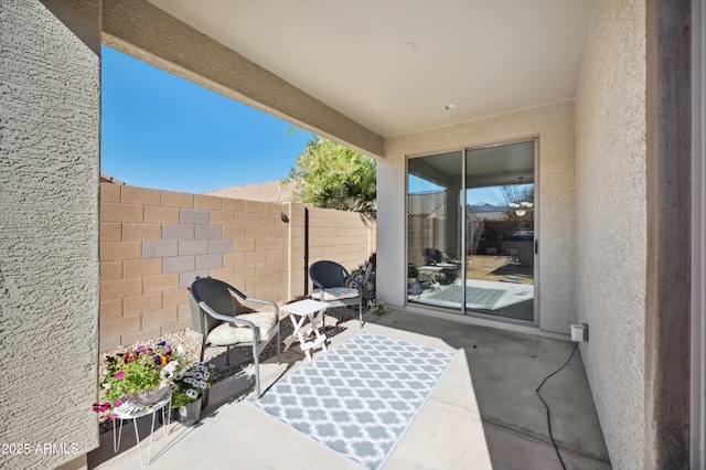 view of patio featuring fence