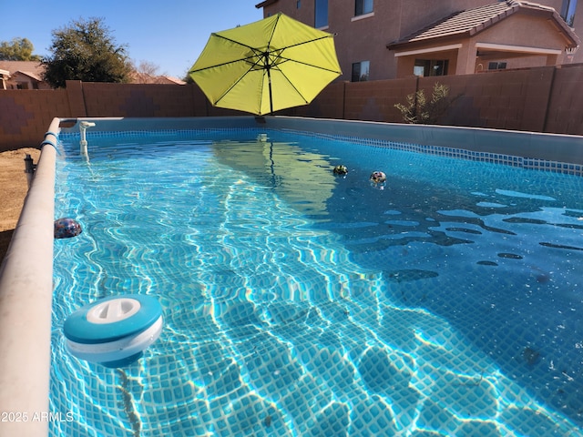 view of pool with a fenced backyard and a fenced in pool