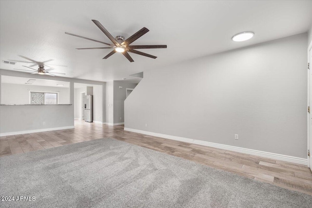 unfurnished living room with ceiling fan and light hardwood / wood-style floors