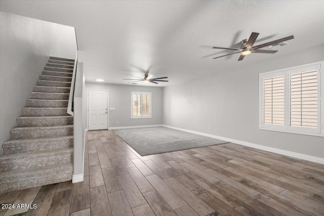 unfurnished living room featuring ceiling fan and wood-type flooring