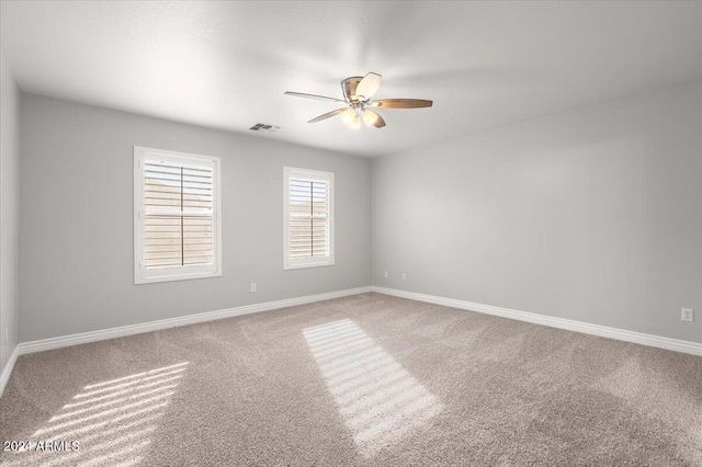 carpeted empty room with ceiling fan