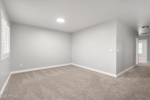 unfurnished room with plenty of natural light and carpet floors