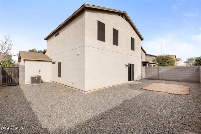 back of house with central air condition unit and a patio area