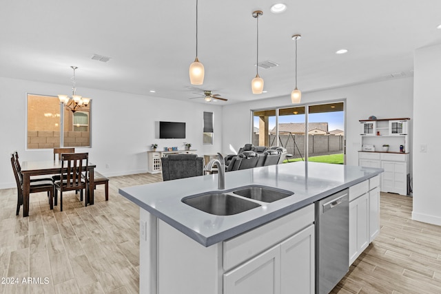 kitchen with dishwasher, light hardwood / wood-style floors, white cabinetry, and an island with sink