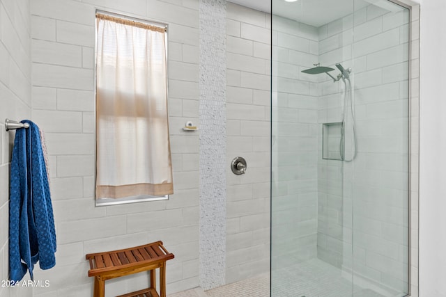 bathroom with a tile shower