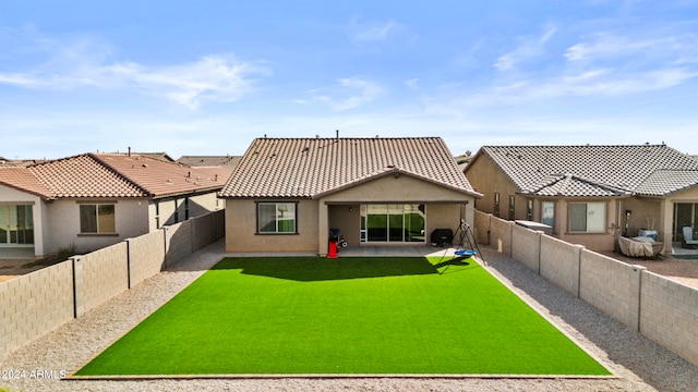 rear view of house with a patio area and a yard