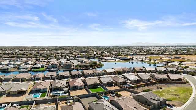 birds eye view of property with a water and mountain view