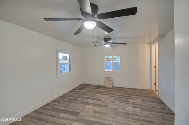 empty room with hardwood / wood-style flooring and plenty of natural light