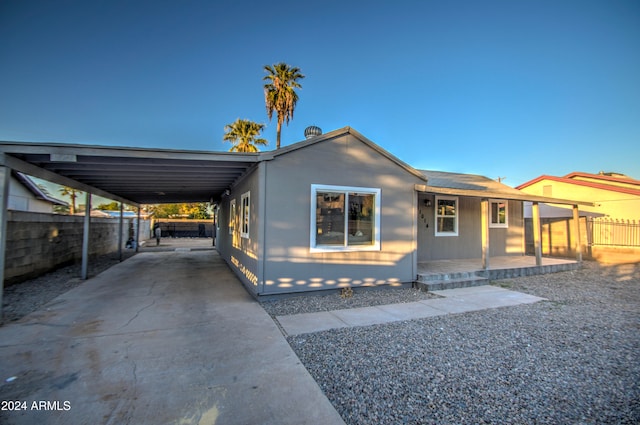 view of front of property featuring a carport and a porch