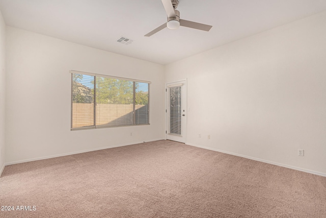 spare room with carpet and ceiling fan